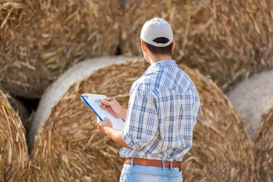 Farmer taking notes in the work